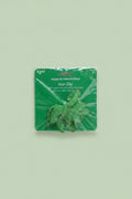 The Flip Side green floral St. Patrick's Day hair clip with shimmering petal details in original retail packaging.
