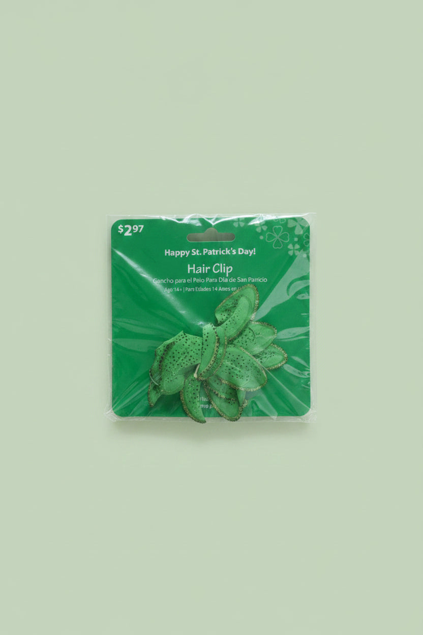The Flip Side green floral St. Patrick's Day hair clip with shimmering petal details in original retail packaging.