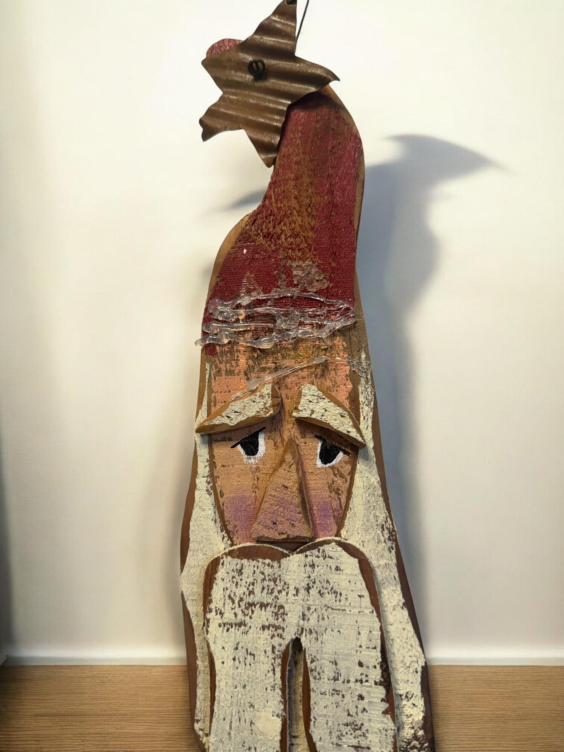 The Flip Side handcrafted wooden Santa Claus wall hanging with a distressed red hat, metal star, and antique white beard.