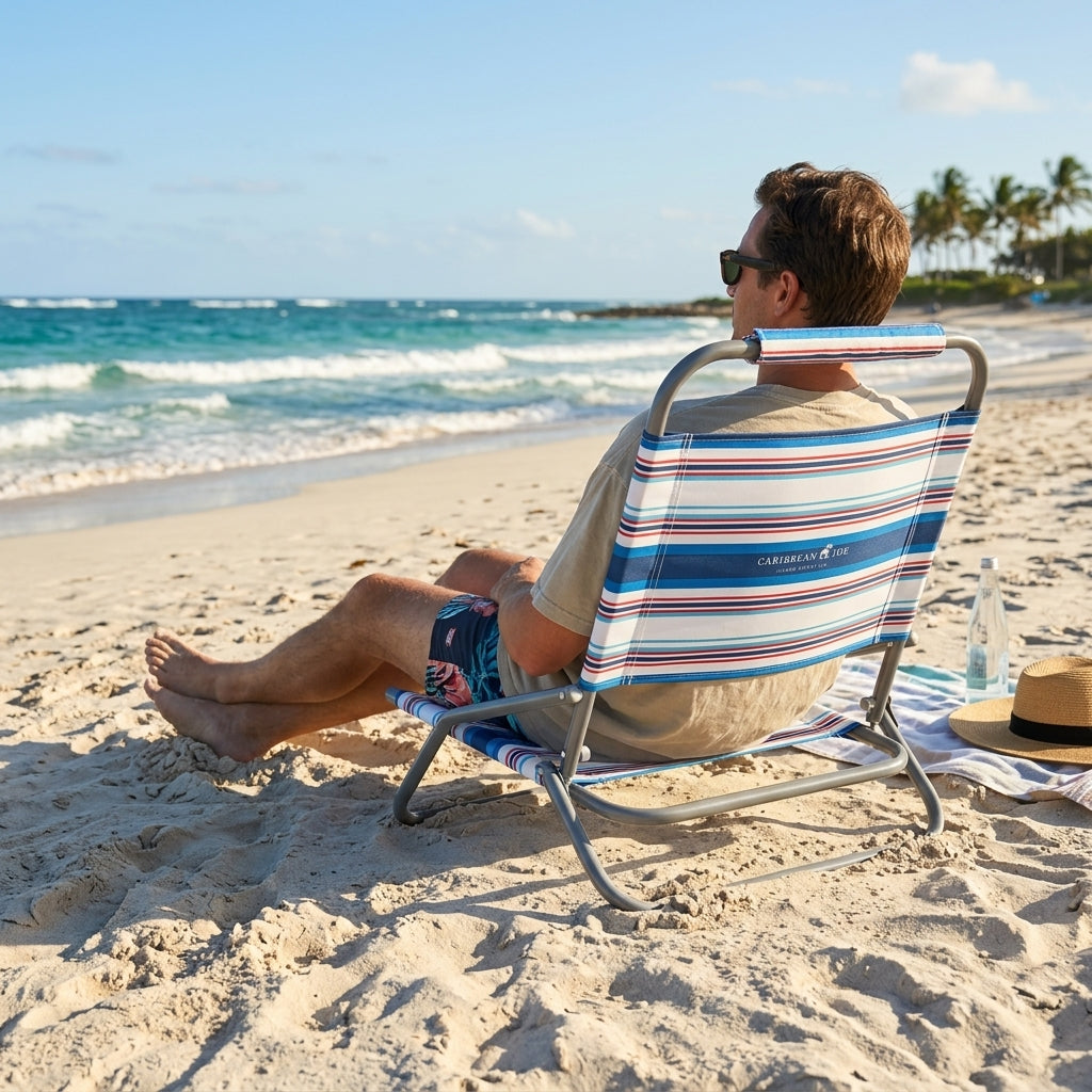 Adult relaxing outdoors in the Caribbean Joe low-profile striped beach chair