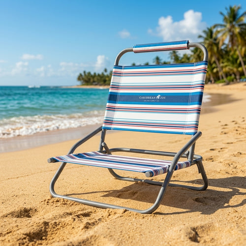 Caribbean Joe low-profile folding beach chair set up on a sunny sandy beach