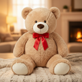 Giant plush brown teddy bear seated on white studio background